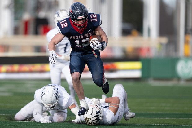Landon Kalsbeck (12) of the Dakota Ridge Eagles breaks multiple tackles on his way to a long touchdown run against the Palmer Ridge Bears during the 4A high school football state championship game on Saturday, Dec. 6, 2025, at Canvas Stadium in Fort Collins, Colo. (Photo by Timothy Hurst/The Denver Post)