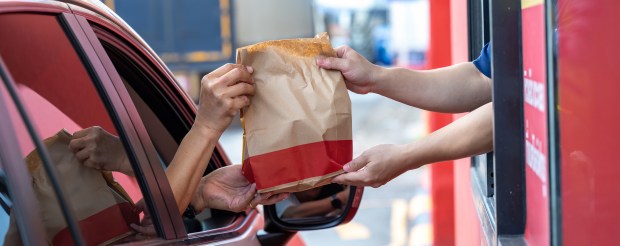 Thirteen-dollar meals times four people adds up to nearly $60 for my family's beloved Good Times burgers and fries. (Getty Images)